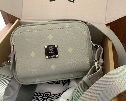 Small sage-green crossbody bag with an adjustable strap