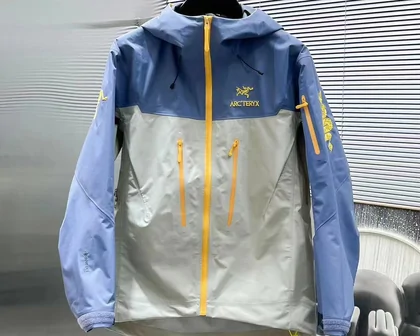 Blue and cream outdoor jacket with yellow zips