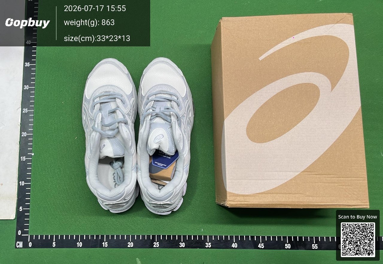 A pair of grey sneakers and their box on an Oopbuy inspection mat with measurement rulers
